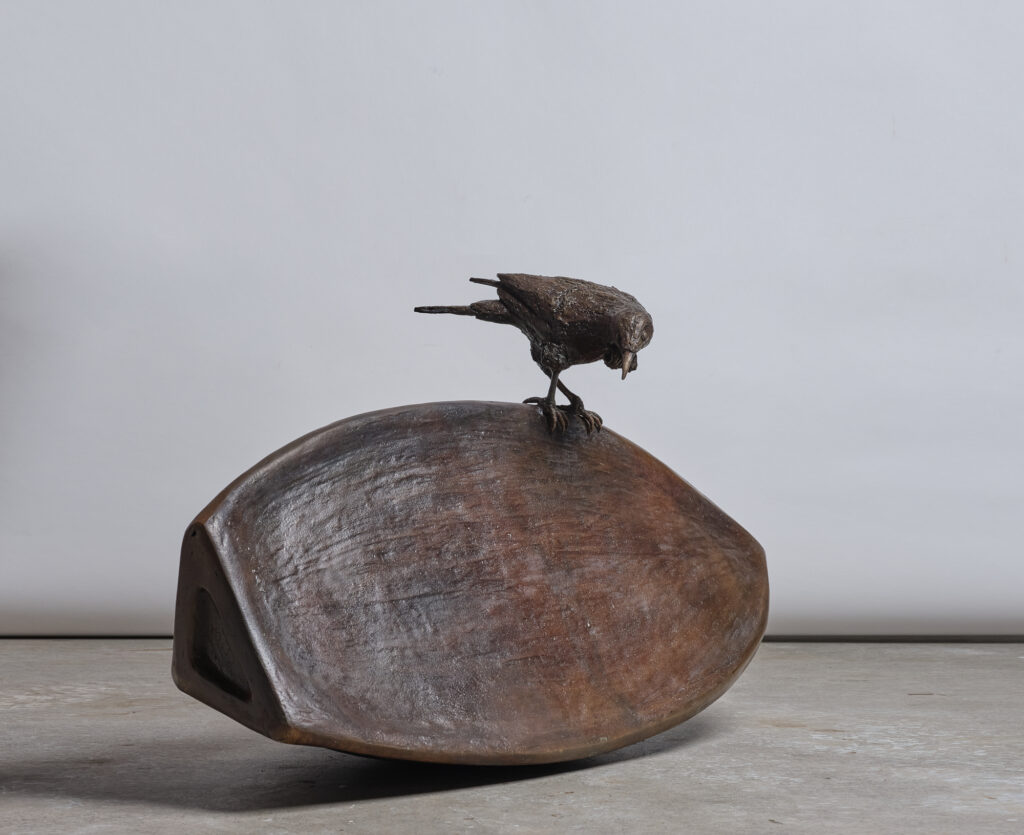 giant bronze seed with a tui perched on top